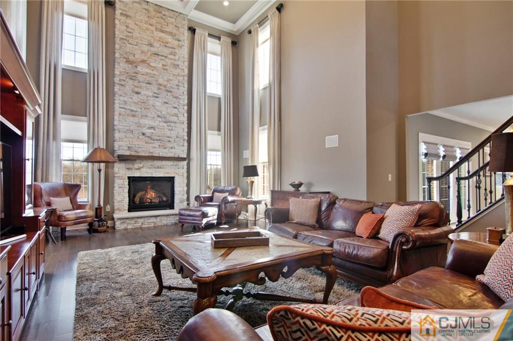 25 Preakness Drive Monroe Township, NJ 08831 - Photo 11 of 48 a living room with furniture a fireplace and a large window