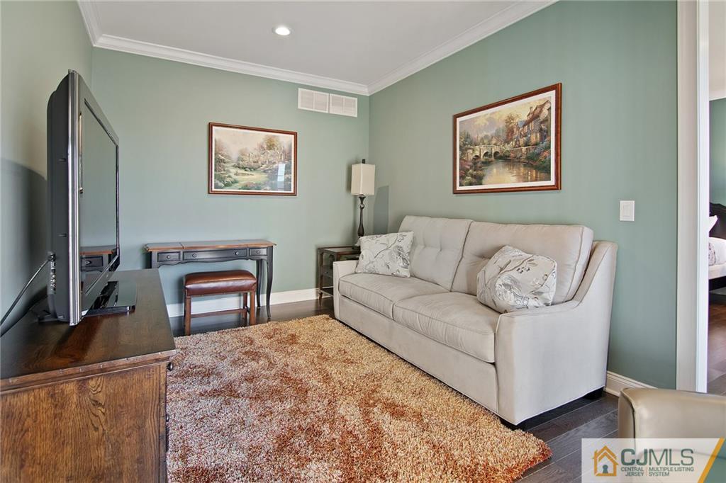 25 Preakness Drive Monroe Township, NJ 08831 - Photo 14 of 48 a living room with furniture and a flat screen tv