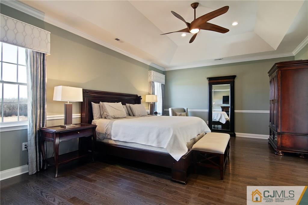 25 Preakness Drive Monroe Township, NJ 08831 - Photo 20 of 48 a bedroom with a bed and wooden floor