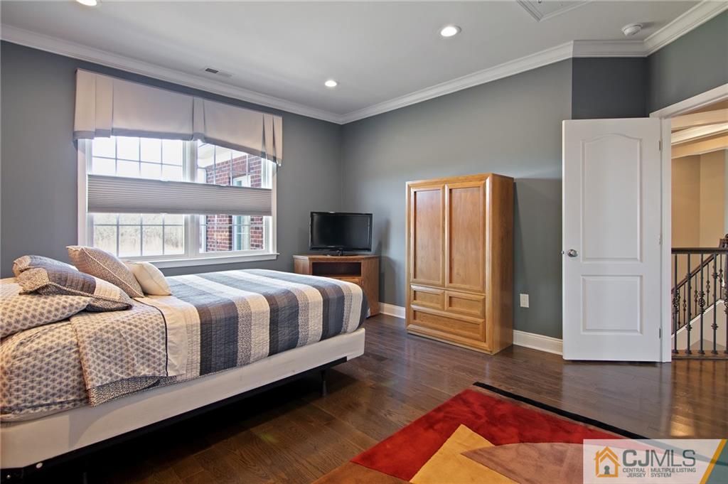 25 Preakness Drive Monroe Township, NJ 08831 - Photo 30 of 48 a bedroom with a bed and wooden floor