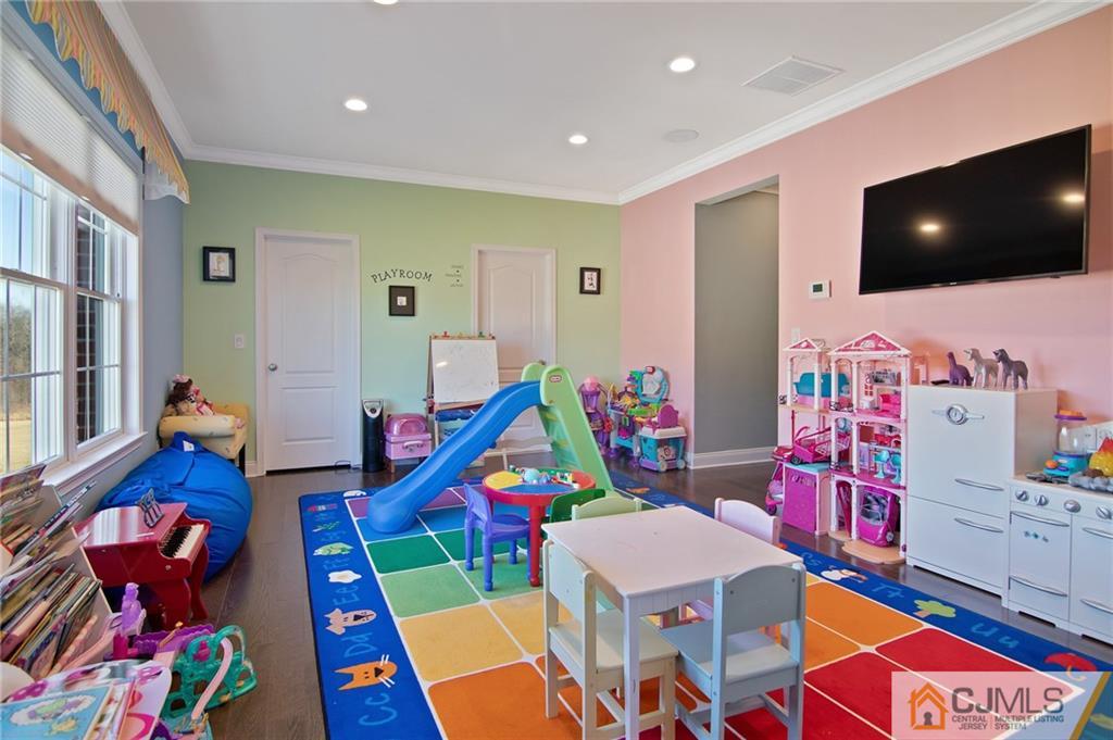 25 Preakness Drive Monroe Township, NJ 08831 - Photo 31 of 48 a living room filled with furniture and a flat screen tv