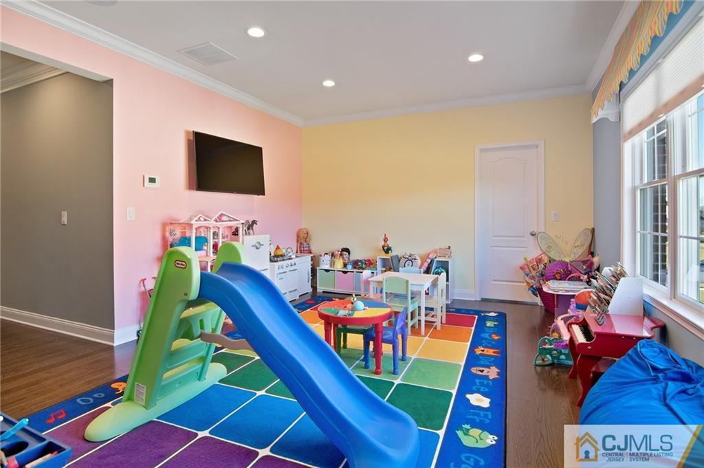 25 Preakness Drive Monroe Township, NJ 08831 - Photo 32 of 48 a room with furniture and a flat screen tv