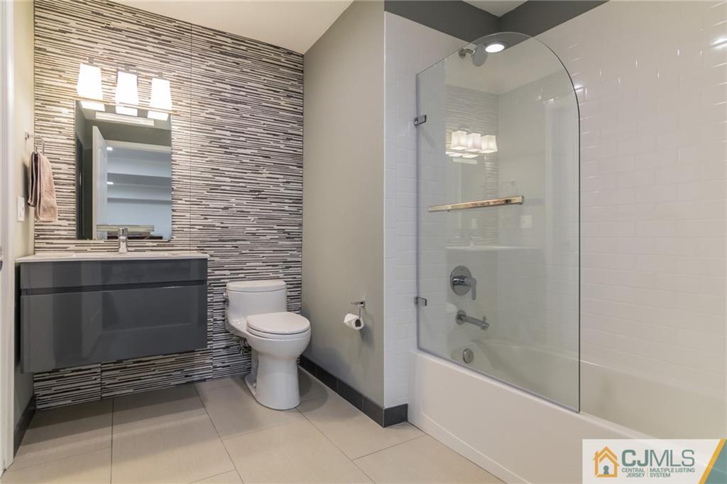 25 Preakness Drive Monroe Township, NJ 08831 - Photo 41 of 48 a bathroom with a toilet a sink and bathtub