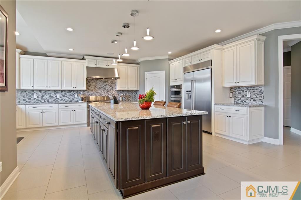 25 Preakness Drive Monroe Township, NJ 08831 - Photo 6 of 48 a kitchen with stainless steel appliances granite countertop a sink stove and cabinets