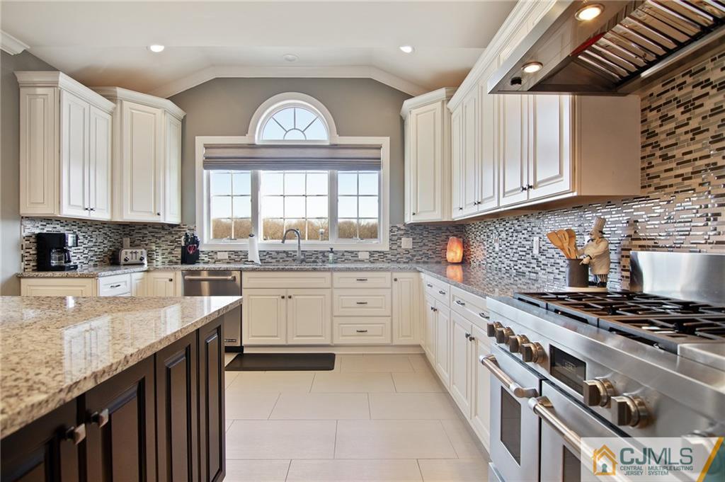 25 Preakness Drive Monroe Township, NJ 08831 - Photo 8 of 48 a kitchen with a stove a sink and a window