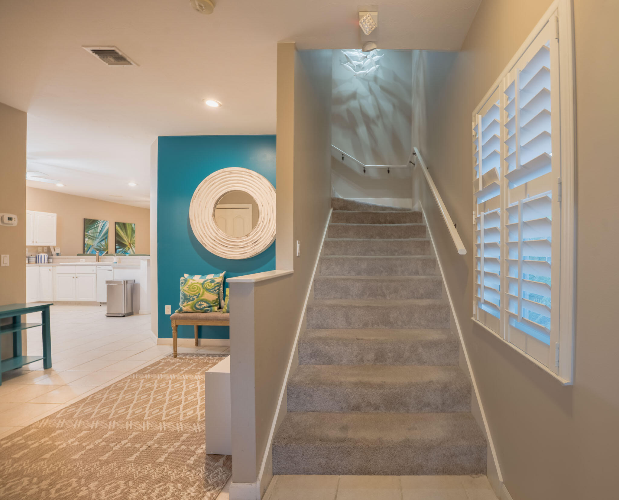 180 9th Street Key Colony Beach, FL 33051 - Photo 11 of 38 a view of a hallway to a livingroom with furniture and staircase