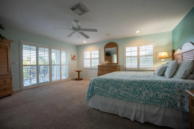 a spacious bedroom with a large bed and a large window