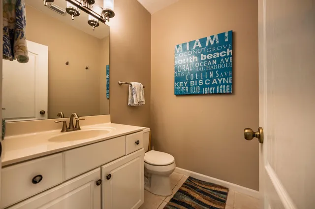 a bathroom with a sink toilet and vanity