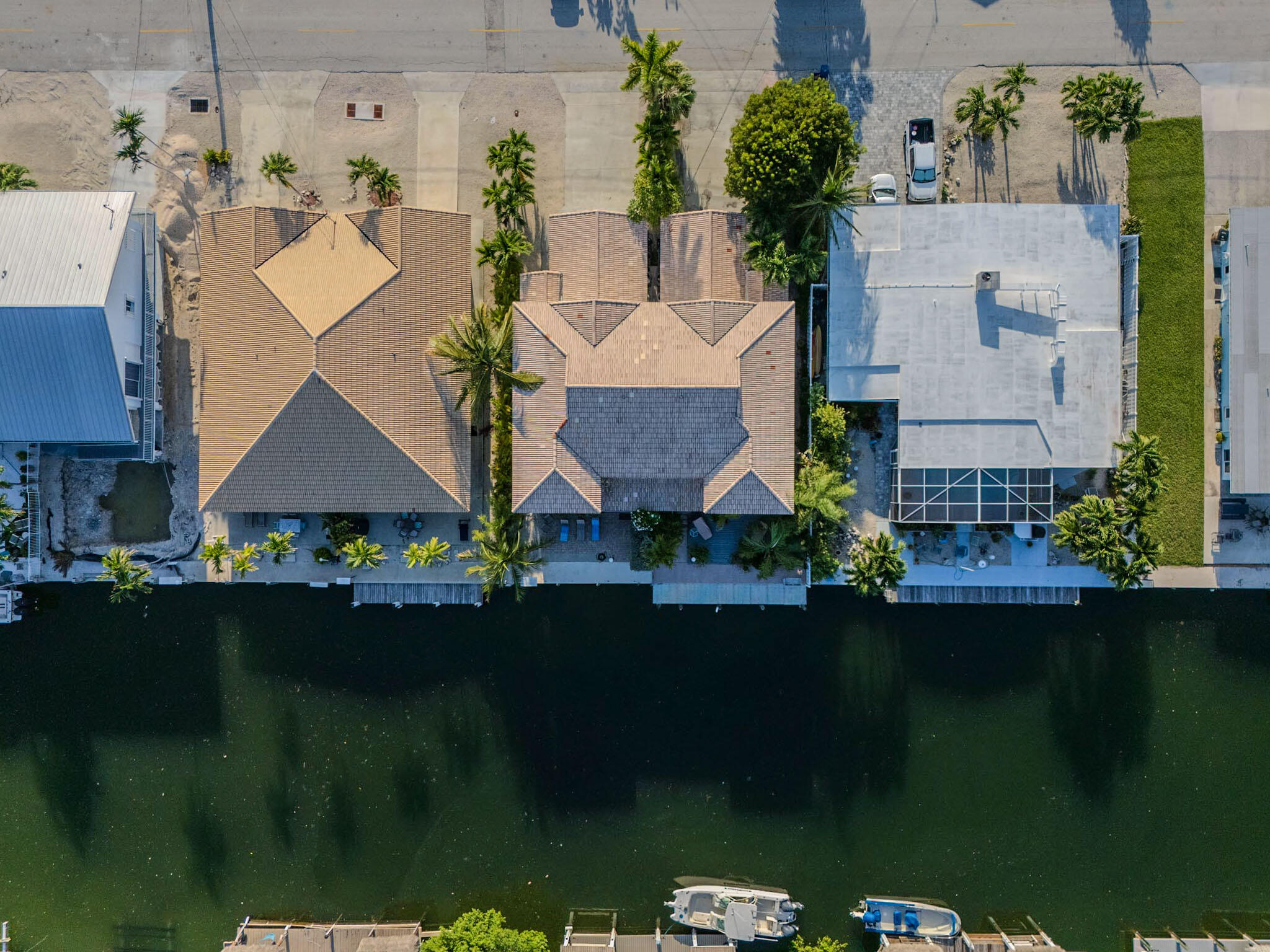 180 9th Street Key Colony Beach, FL 33051 - Photo 30 of 38 an aerial view of a house with pool a yard and a lake view