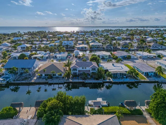an aerial view of residential building and lake