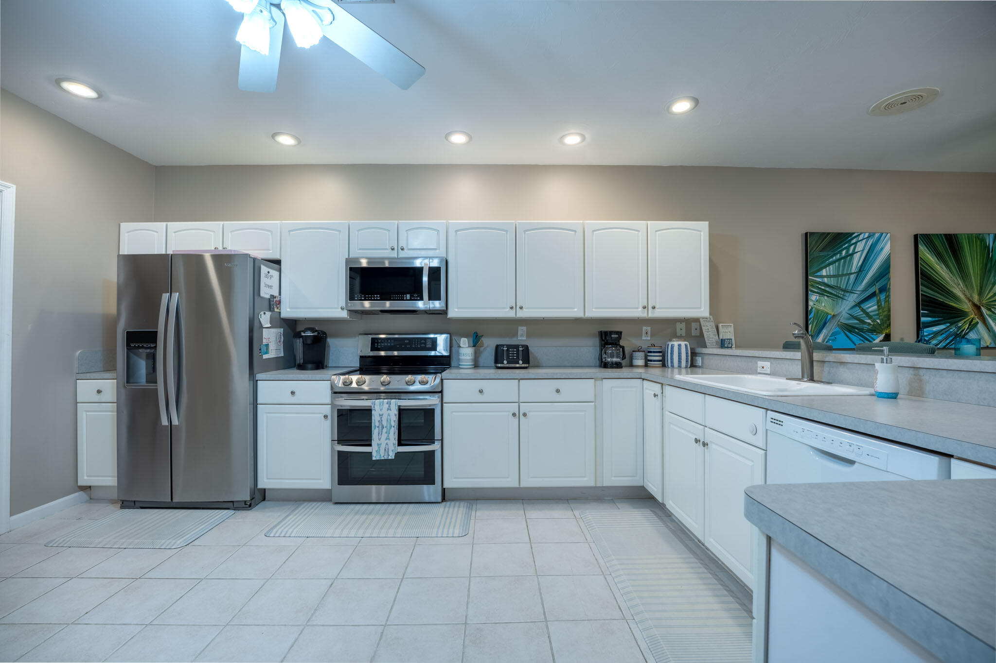 180 9th Street Key Colony Beach, FL 33051 - Photo 4 of 38 a kitchen with a sink cabinets and stainless steel appliances