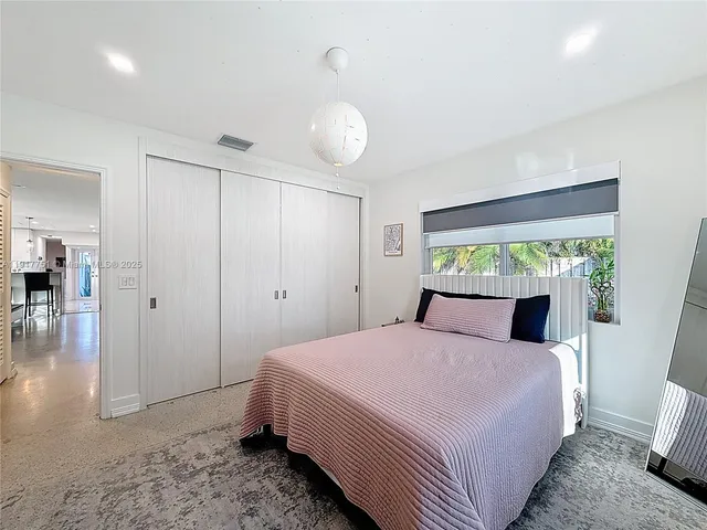 a bedroom with a bed and ceiling fan