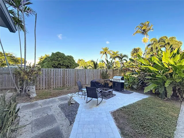 a view of a swimming pool with furniture