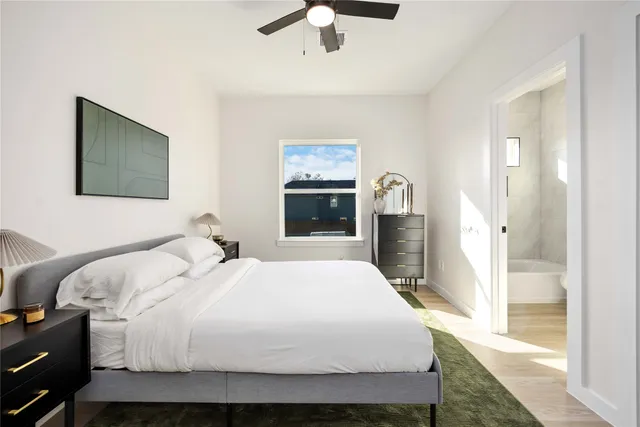 a bedroom with a large bed dresser and window