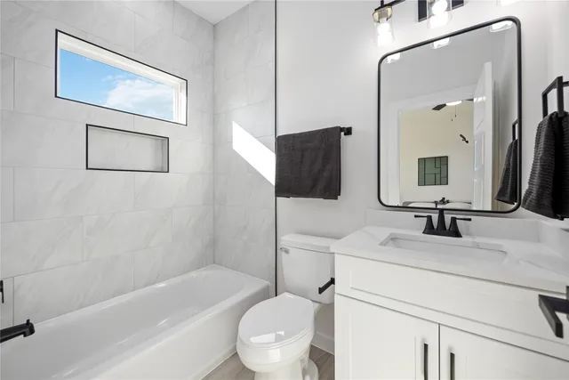 a bathroom with a toilet and a bathtub