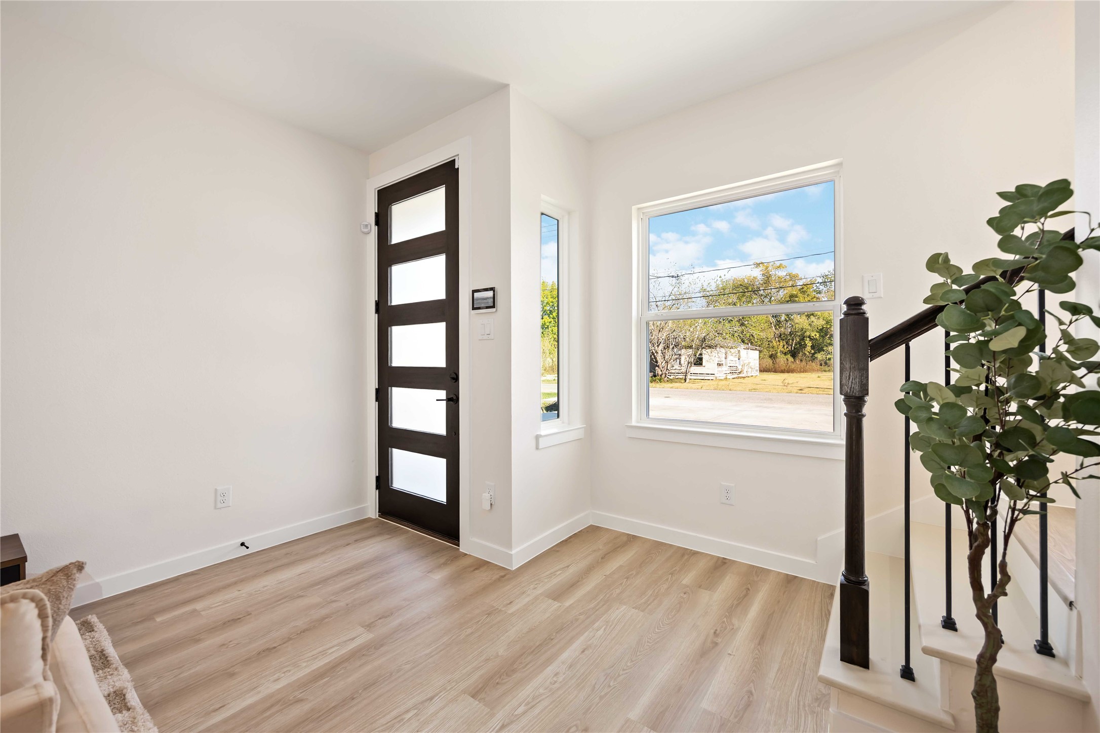 5523 Haight Street, Unit B Houston, TX 77028 - Photo 3 of 17 an empty room with wooden floor and windows