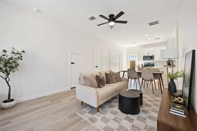 a living room with furniture and wooden floor