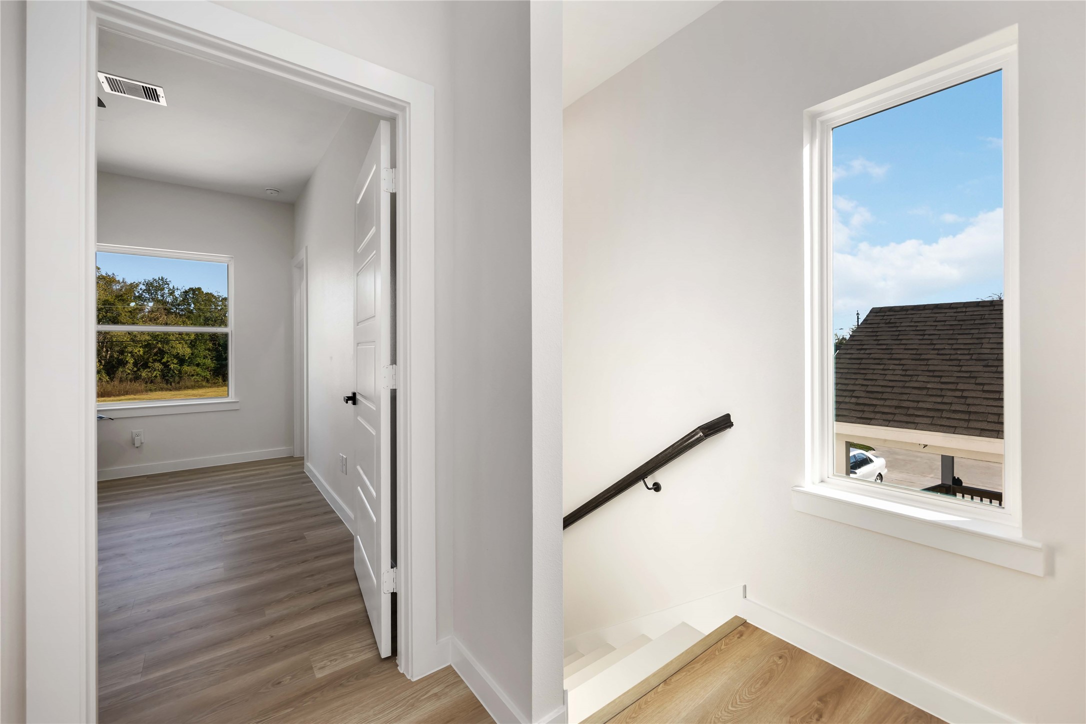5523 Haight Street, Unit B Houston, TX 77028 - Photo 8 of 17 a view of a hallway with wooden floor and staircase