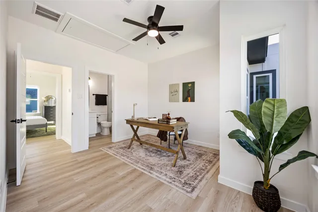 a living room with furniture a dining table and a potted plant