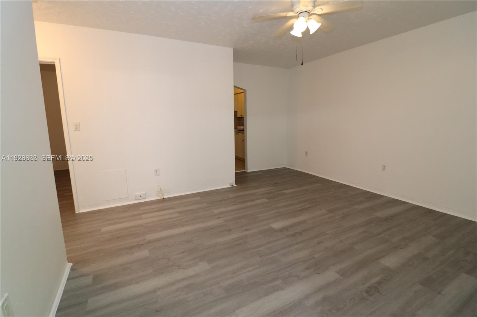 777 Northeast 85th Street, Unit 3 Miami, FL 33138 - Photo 14 of 21 an empty room with wooden floor and hallway