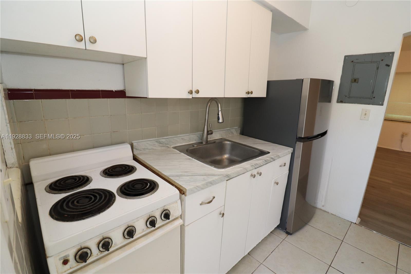 777 Northeast 85th Street, Unit 3 Miami, FL 33138 - Photo 2 of 21 a kitchen with a sink and a stove top oven