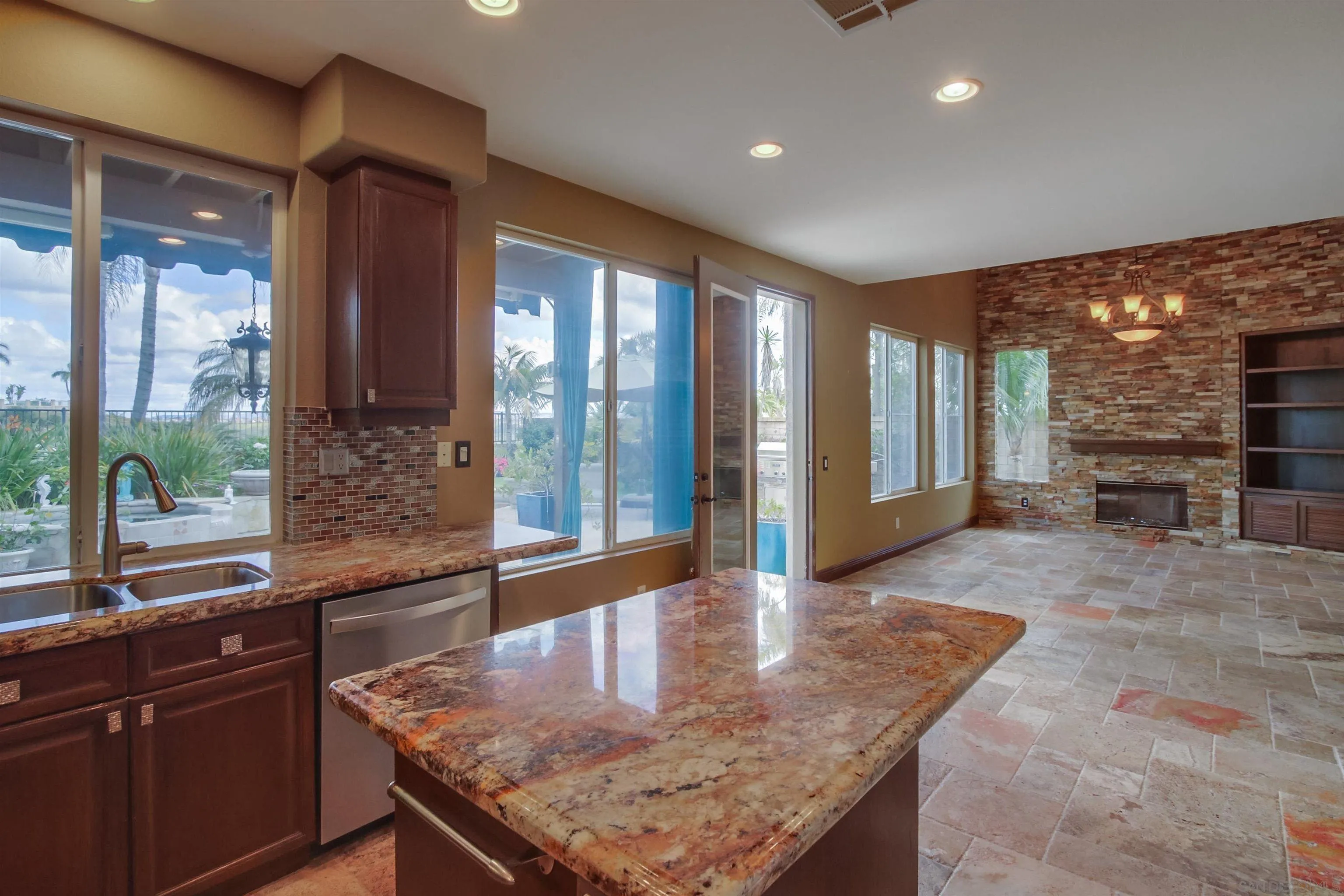 6550 Windward Ridge Way San Diego, CA 92121 - Photo 27 of 64 a kitchen with stainless steel appliances granite countertop a sink and cabinets