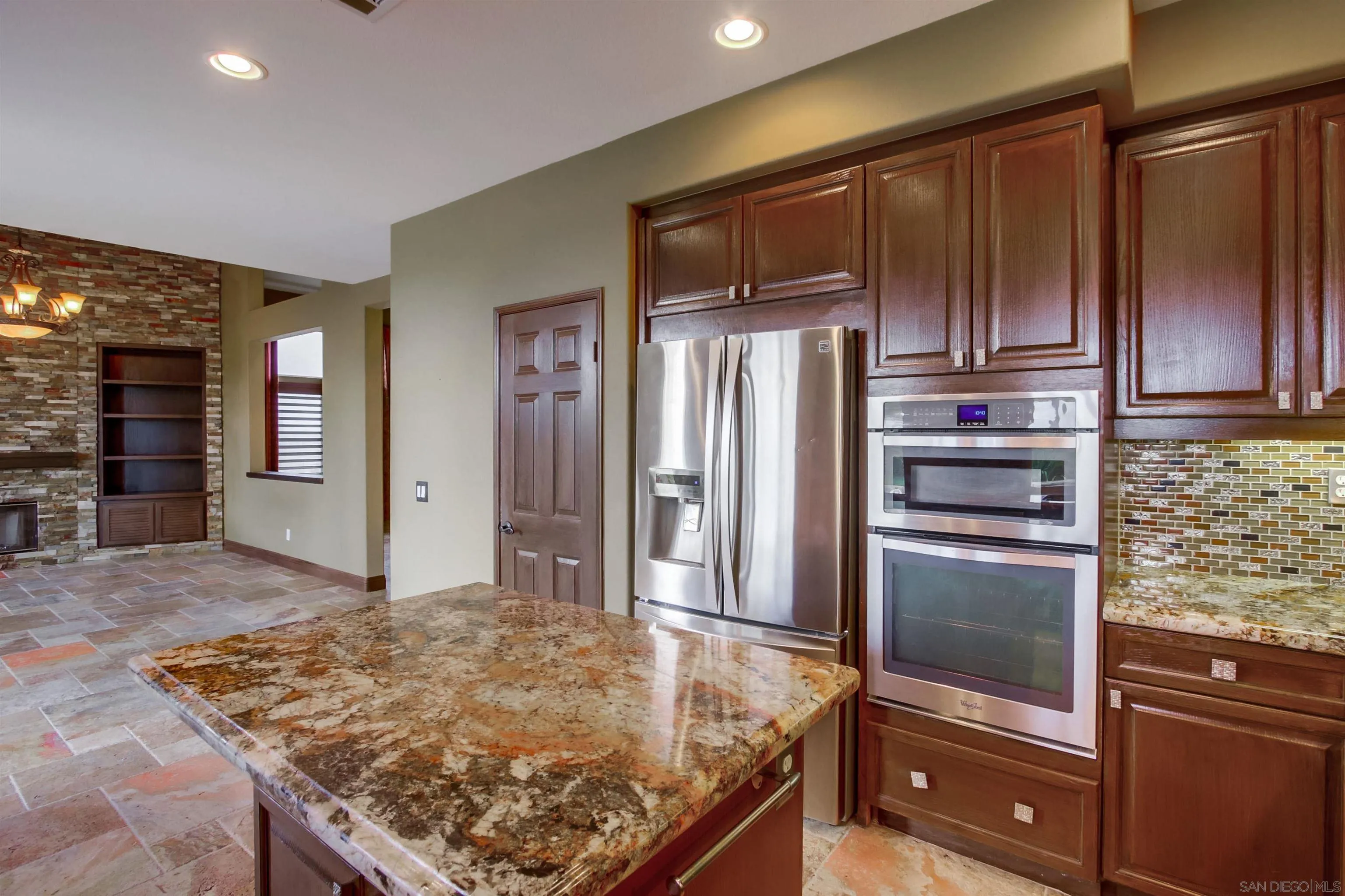 6550 Windward Ridge Way San Diego, CA 92121 - Photo 28 of 64 a kitchen with stainless steel appliances granite countertop a refrigerator and a stove