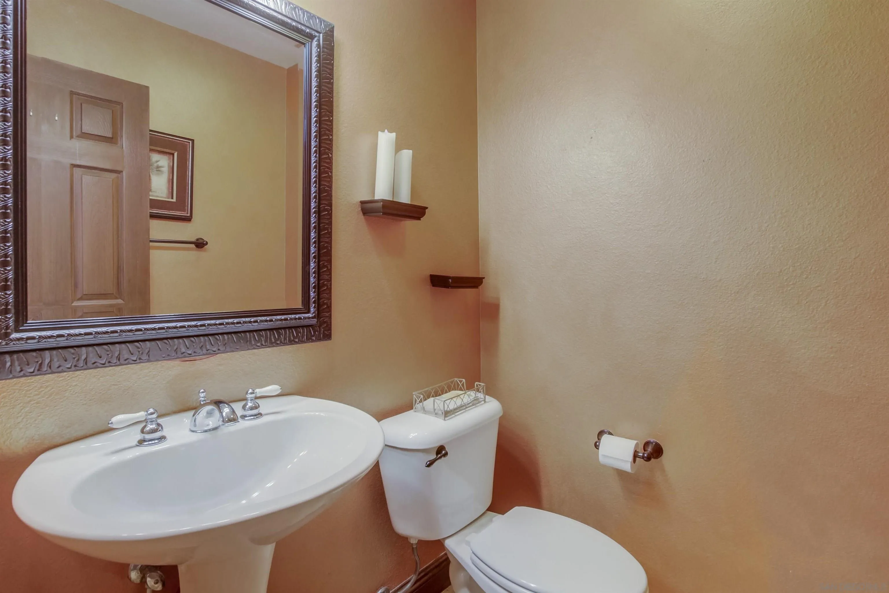 6550 Windward Ridge Way San Diego, CA 92121 - Photo 29 of 64 a bathroom with a sink mirror and toilet