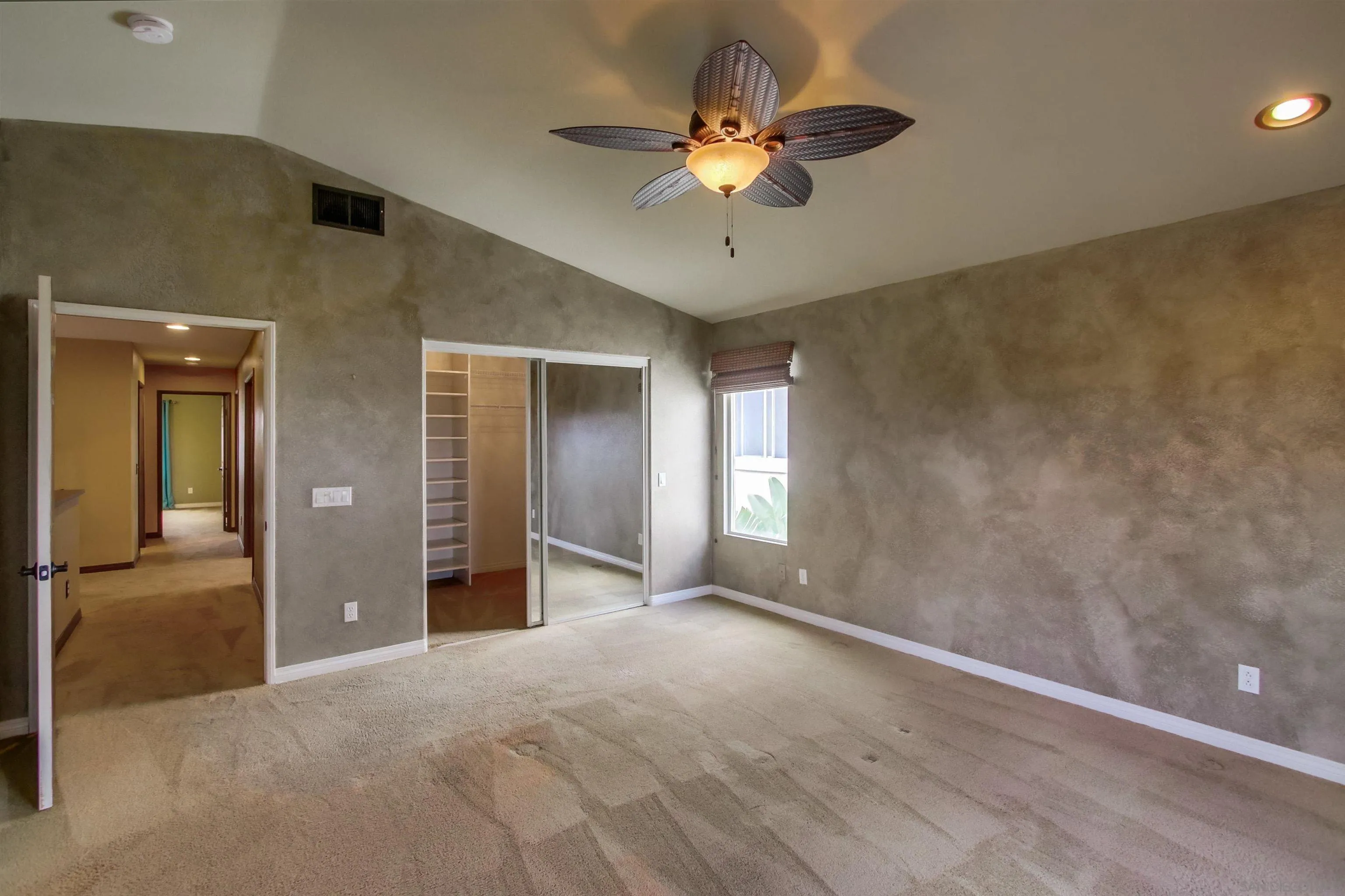 6550 Windward Ridge Way San Diego, CA 92121 - Photo 34 of 64 a view of an empty room with a ceiling fan