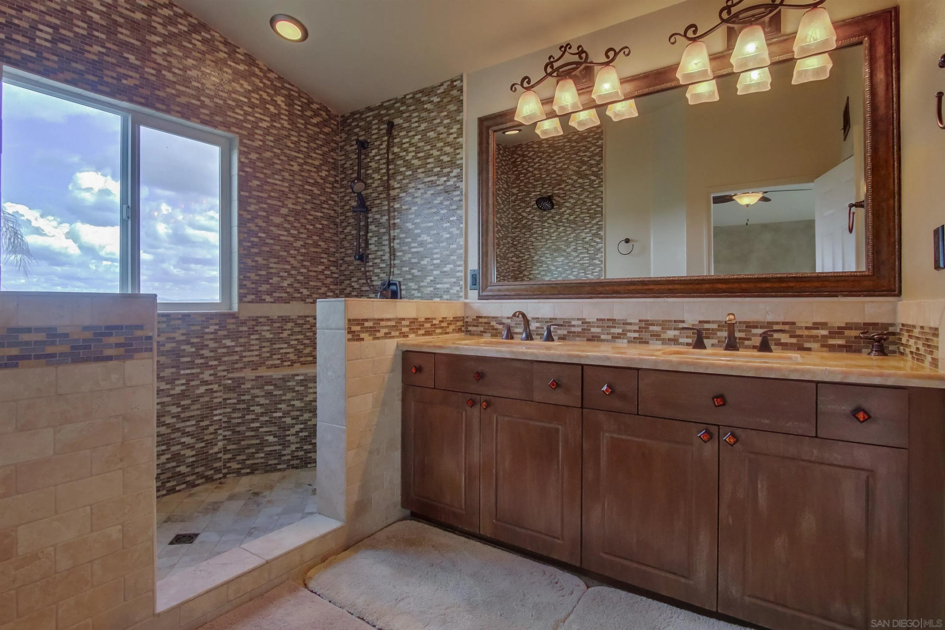 6550 Windward Ridge Way San Diego, CA 92121 - Photo 36 of 64 a bathroom with a sink and a mirror
