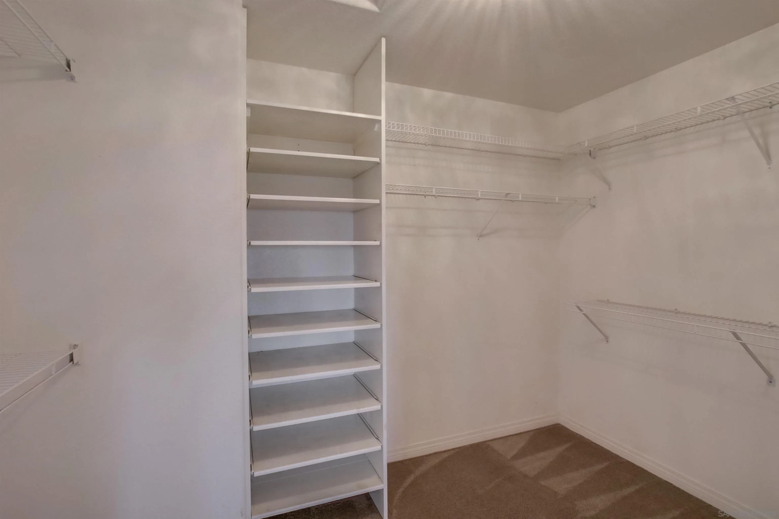 6550 Windward Ridge Way San Diego, CA 92121 - Photo 38 of 64 a view of walk in closet with empty racks