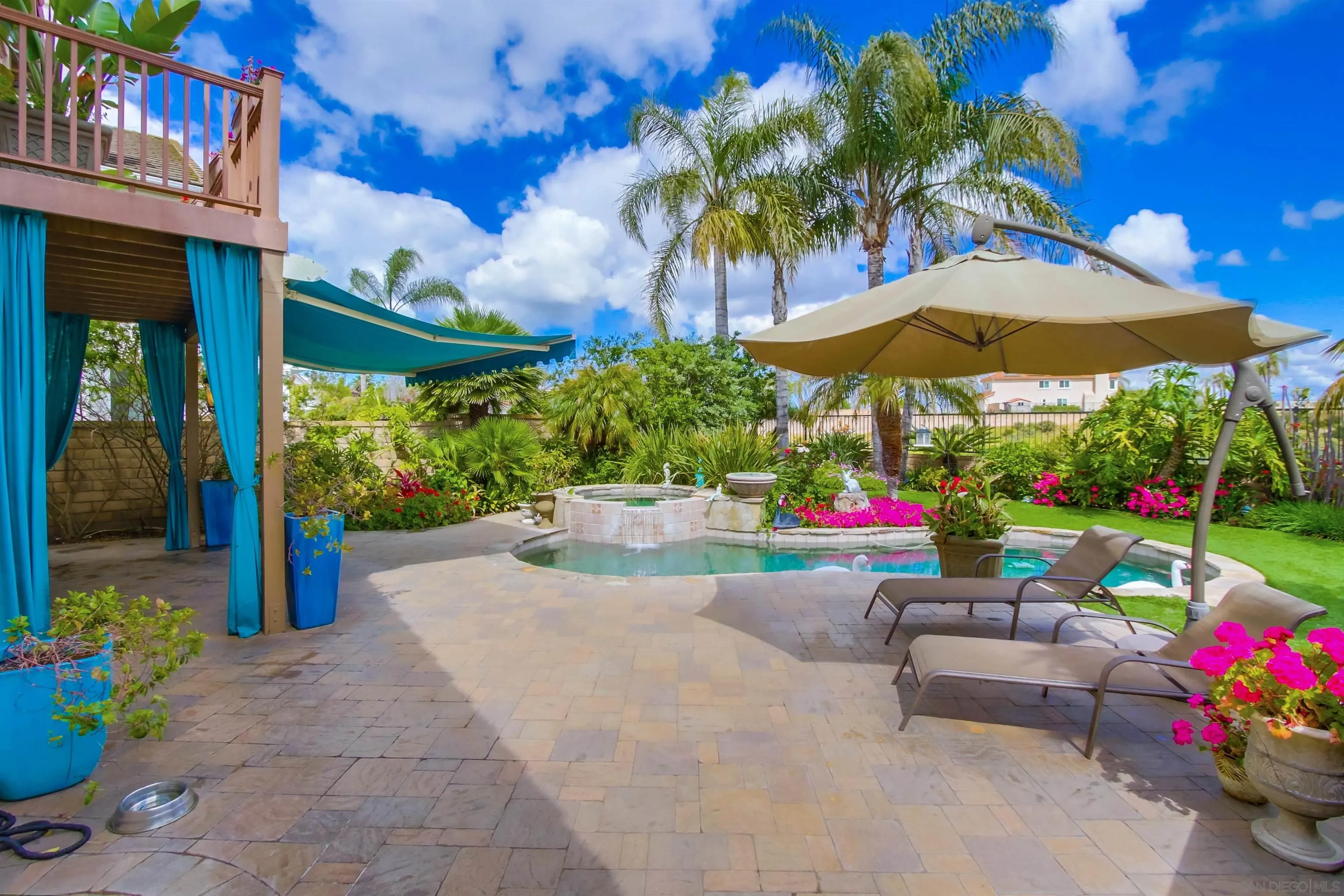 6550 Windward Ridge Way San Diego, CA 92121 - Photo 56 of 64 a view of the patio with a table and chairs under an umbrella