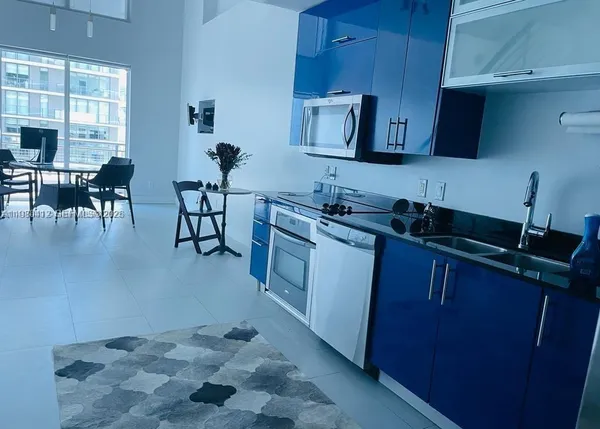 a kitchen with sink cabinets and window