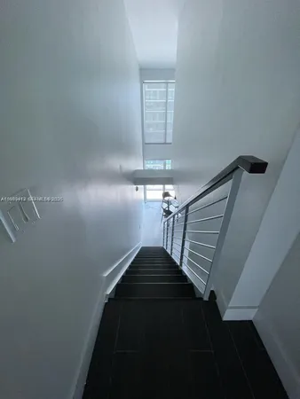 a view of entryway and hall with a front door