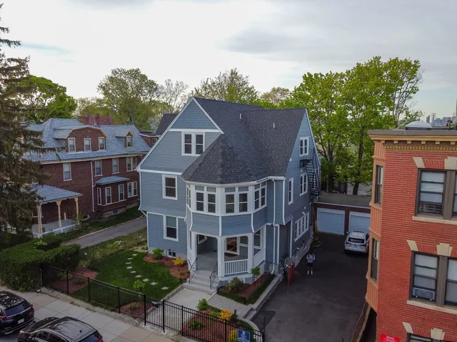 an aerial view of a house with a yard
