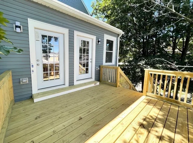 a view of a house with wooden deck