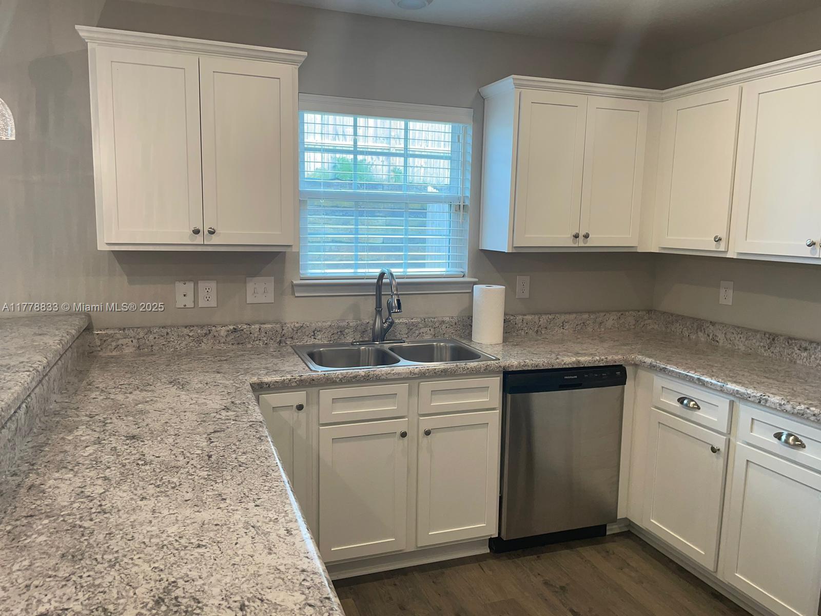 219 Wainwright Drive Crestview, FL 32539 - Photo 11 of 31 a kitchen with stainless steel appliances granite countertop a sink stove and cabinets