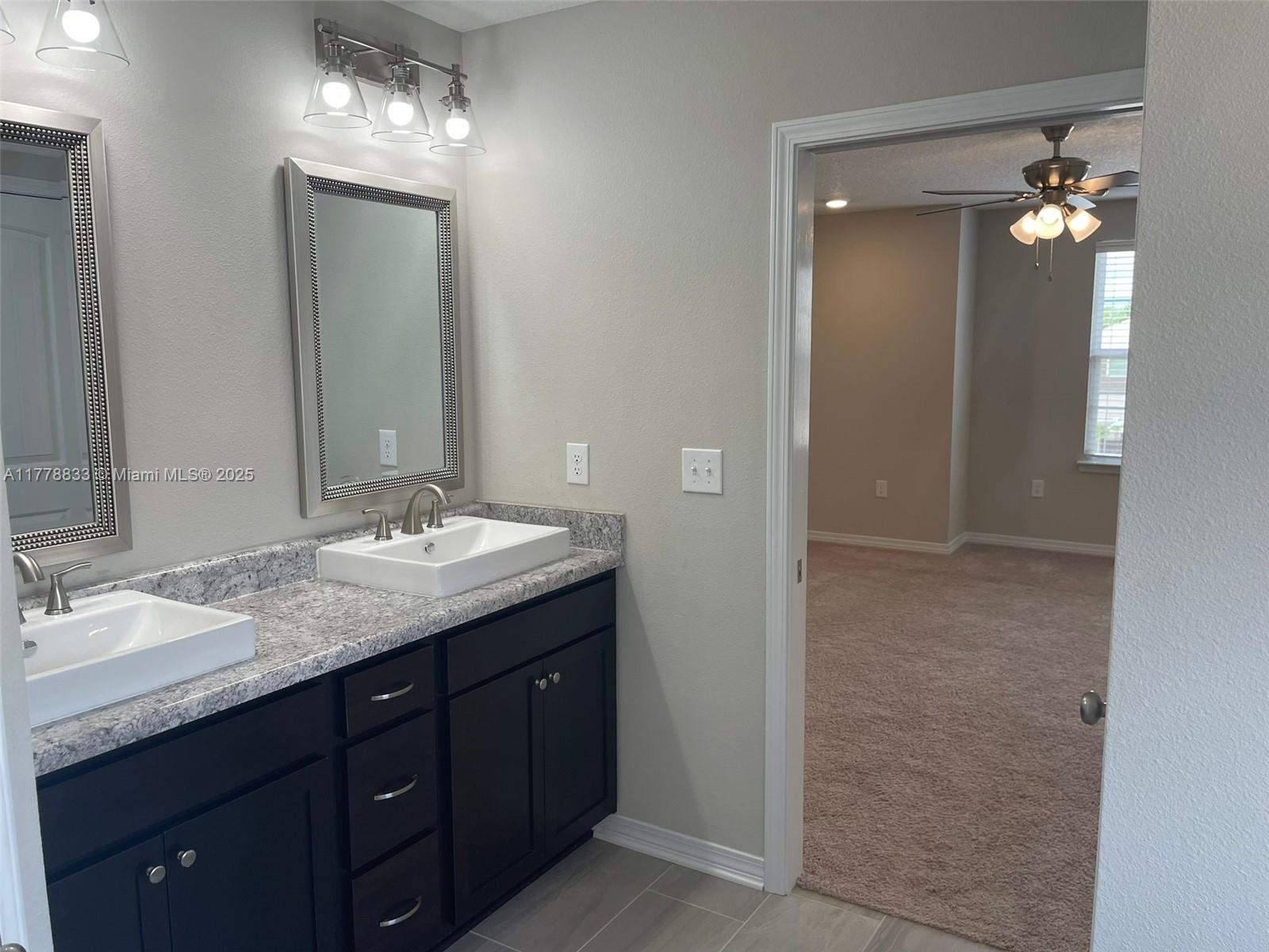 219 Wainwright Drive Crestview, FL 32539 - Photo 22 of 31 a bathroom with double vanity sink a vanity a lamp and a mirror