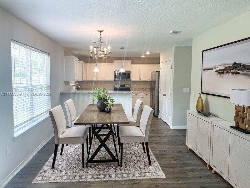 219 Wainwright Drive Crestview, FL 32539 - Photo 3 of 31 a view of a dining room with furniture and a chandelier