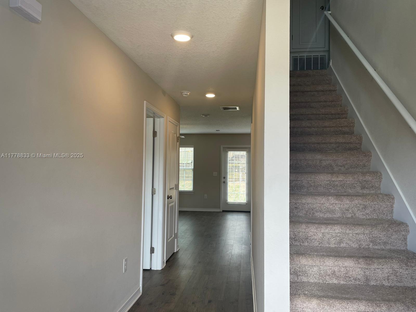219 Wainwright Drive Crestview, FL 32539 - Photo 8 of 31 a view of a hallway with wooden floor and staircase