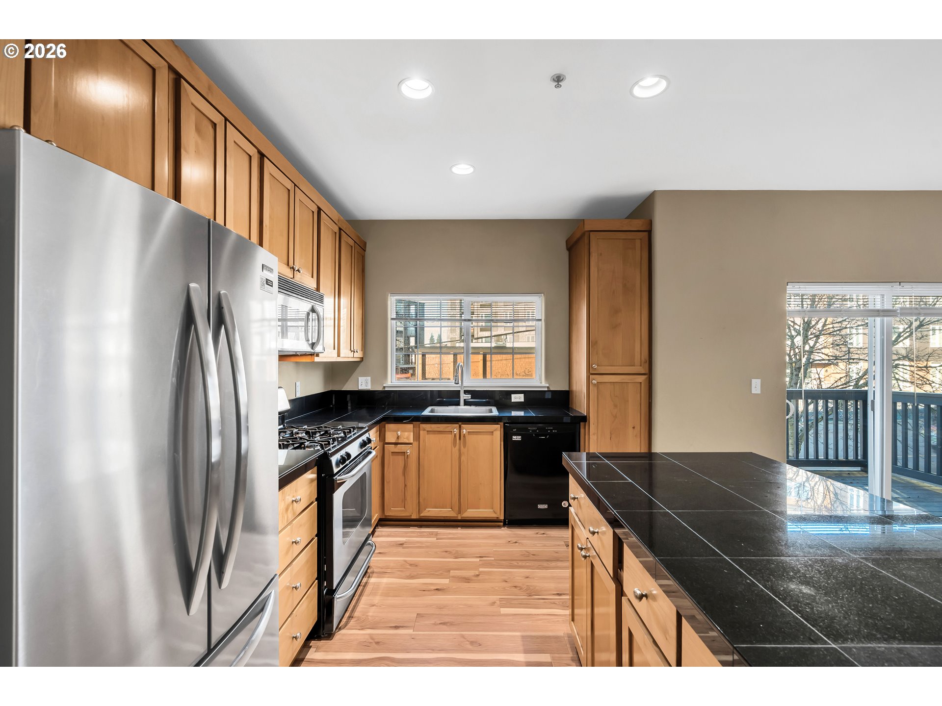1000 Southwest 170th Avenue, Unit 201 Beaverton, OR 97003 - Photo 8 of 37 a kitchen with granite countertop a stove a refrigerator and a sink