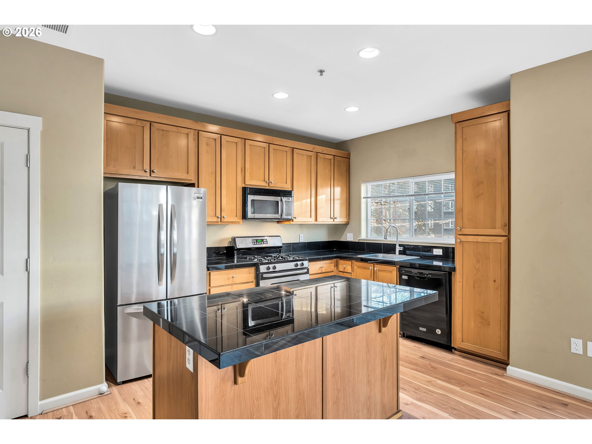 1000 Southwest 170th Avenue, Unit 201 Beaverton, OR 97003 - Photo 9 of 37 a kitchen with stainless steel appliances granite countertop a refrigerator a sink a stove a microwave and island