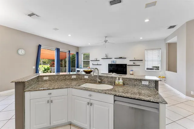 a living room with furniture and kitchen view