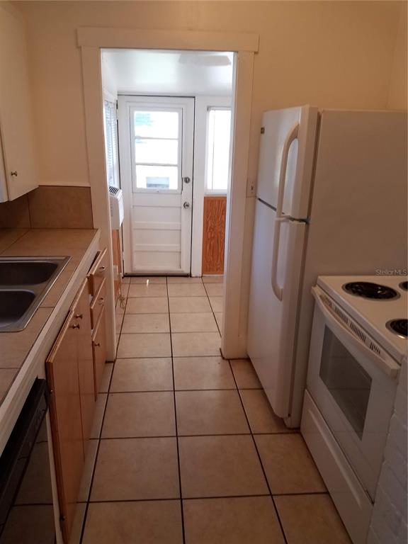 548 3rd Street North St. Petersburg, FL 33701 - Photo 28 of 28 a kitchen with a refrigerator and a stove top oven