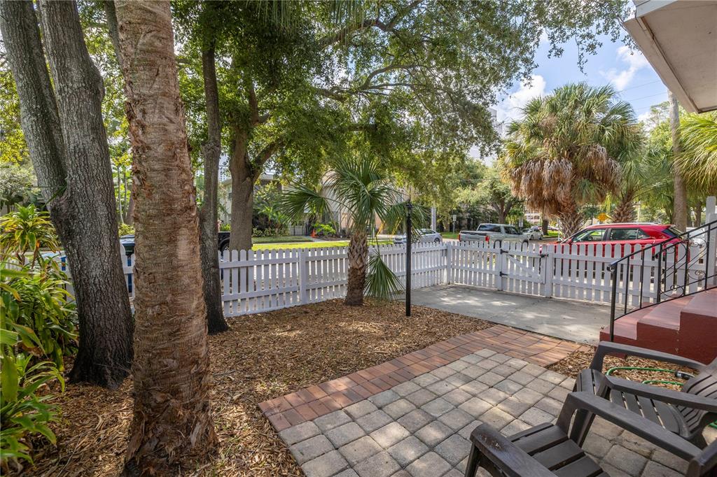 548 3rd Street North St. Petersburg, FL 33701 - Photo 3 of 28 a view of a deck with a fence and trees