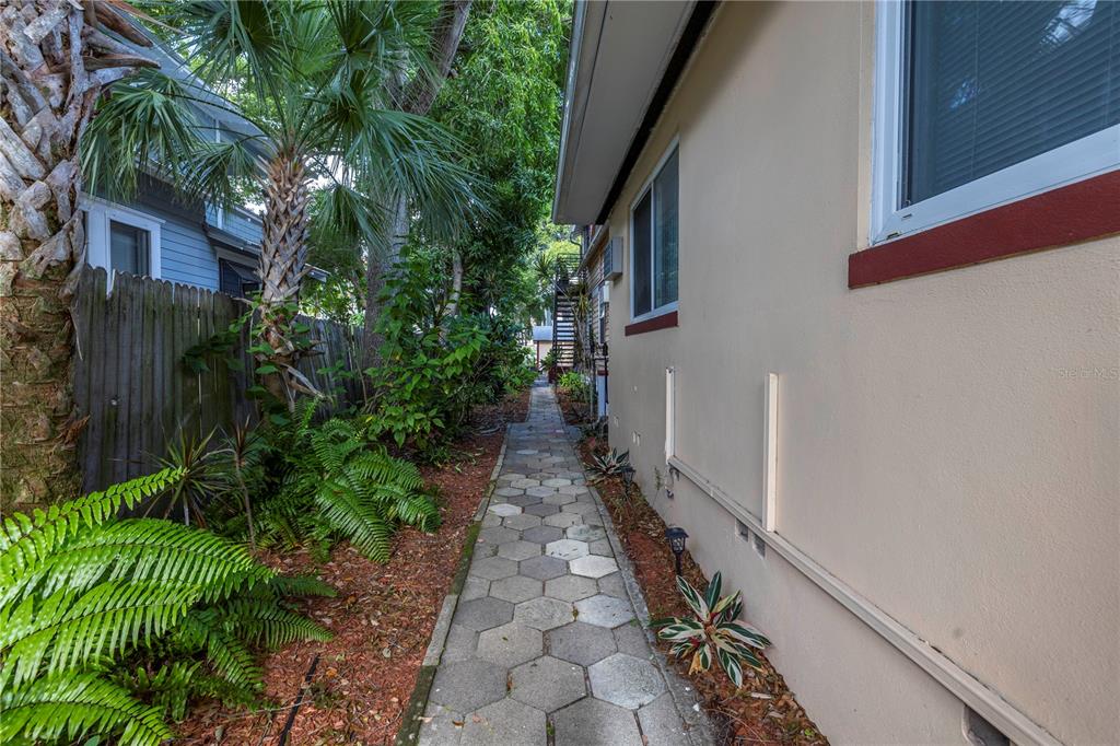548 3rd Street North St. Petersburg, FL 33701 - Photo 5 of 28 a view of a pathway both side of the house
