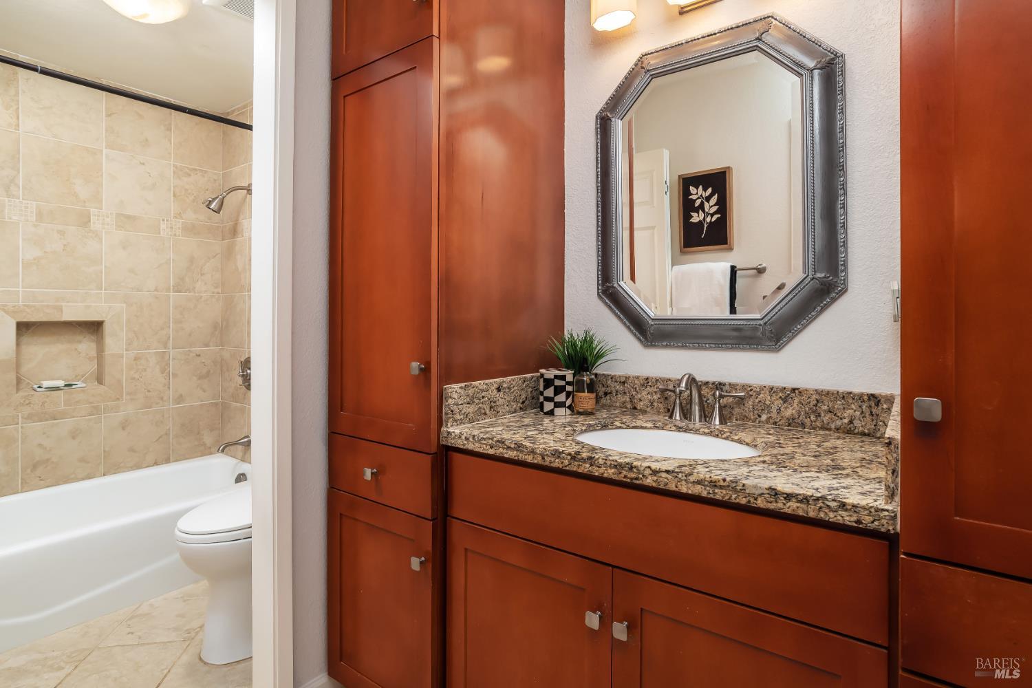 4 California Condor Way Novato, CA 94949 - Photo 11 of 20 a bathroom with a granite countertop sink toilet and mirror