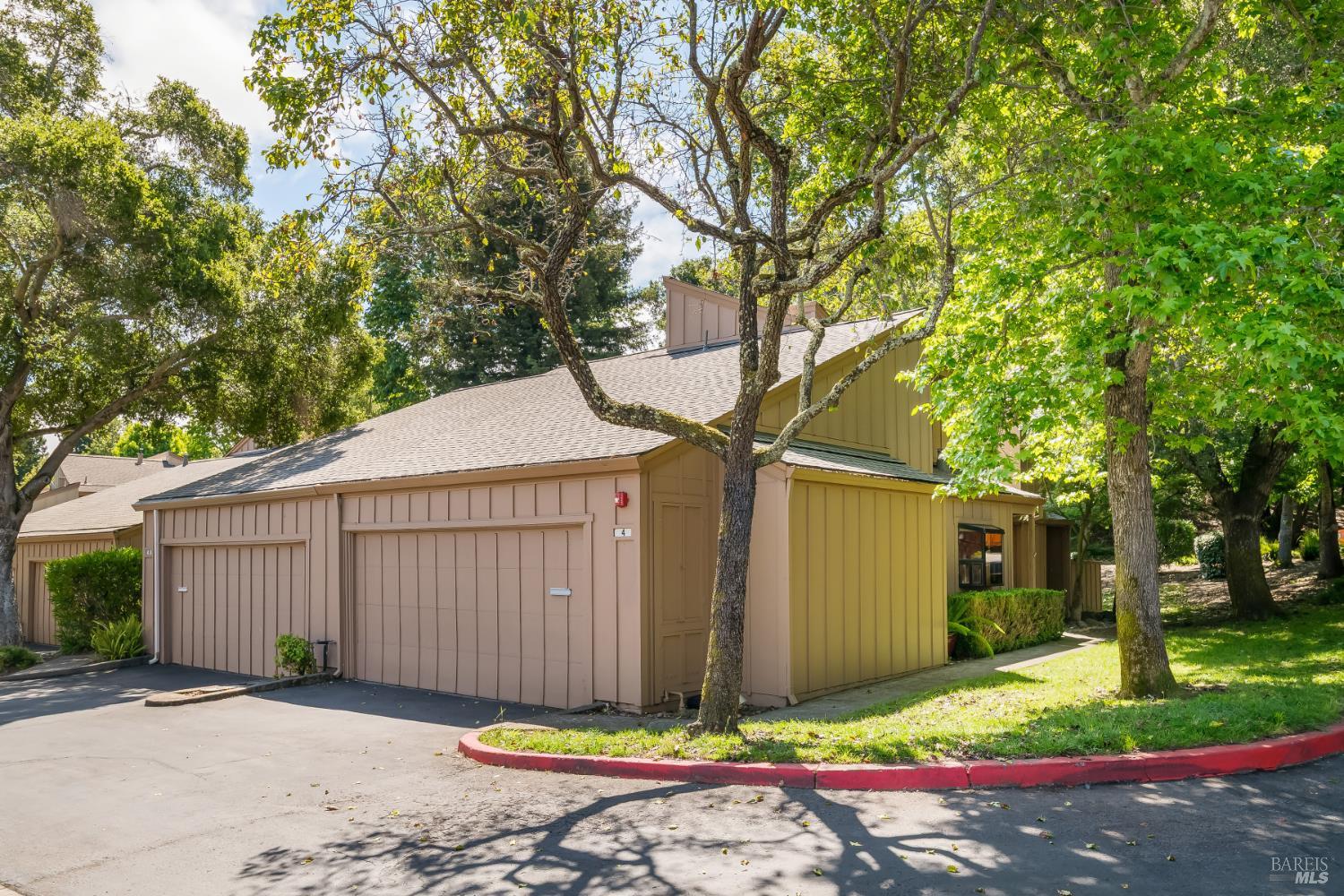 4 California Condor Way Novato, CA 94949 - Photo 17 of 20 a front view of a house with a garden and tree