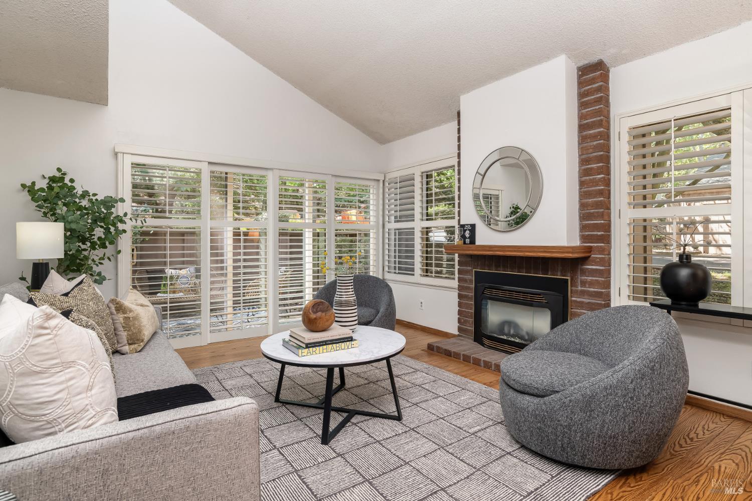 4 California Condor Way Novato, CA 94949 - Photo 4 of 20 a living room with furniture a fireplace and a large window