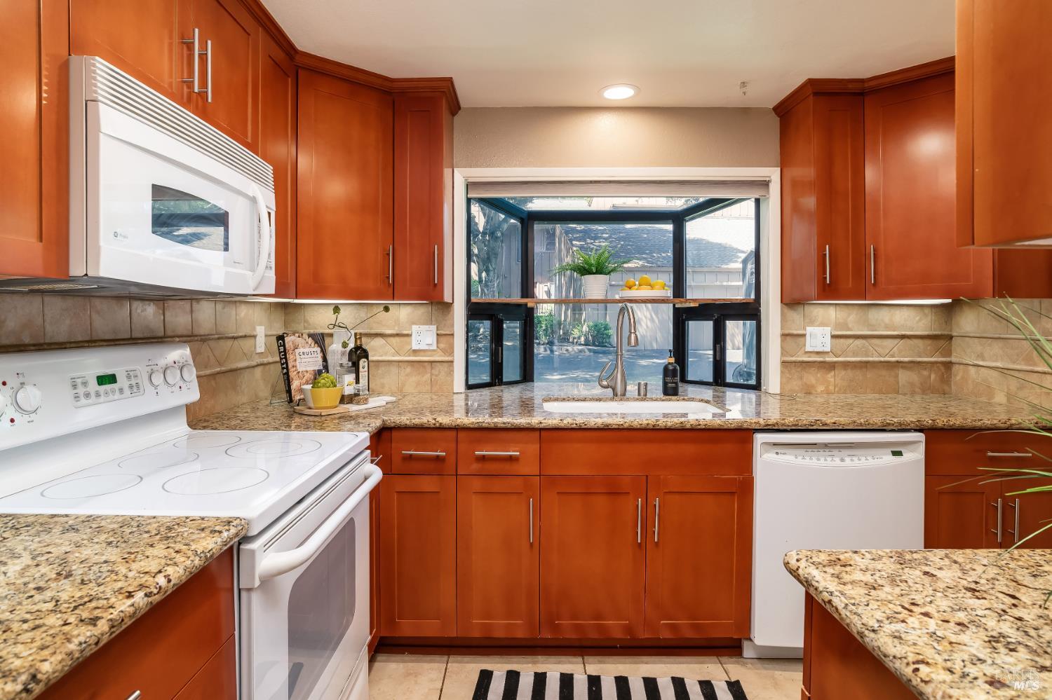 4 California Condor Way Novato, CA 94949 - Photo 9 of 20 a kitchen with stainless steel appliances granite countertop wooden cabinets sink and stove